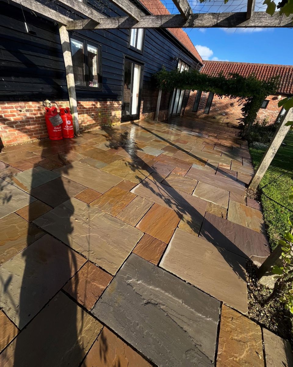 The same Indian sandstone patio after cleaning, with its warm natural colours restored