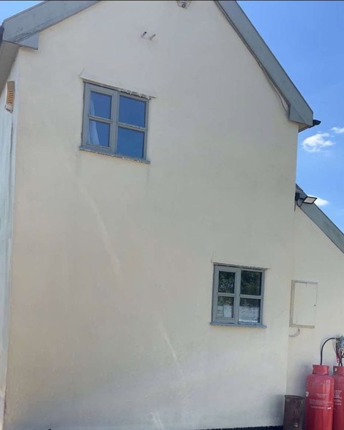 The same rendered wall after a soft wash, clean and evenly cream