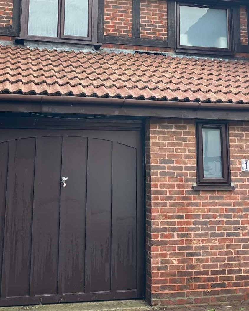 The same garage roof after cleaning, the tiles clean and red again